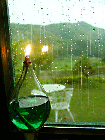 rain and lamp on the window sill